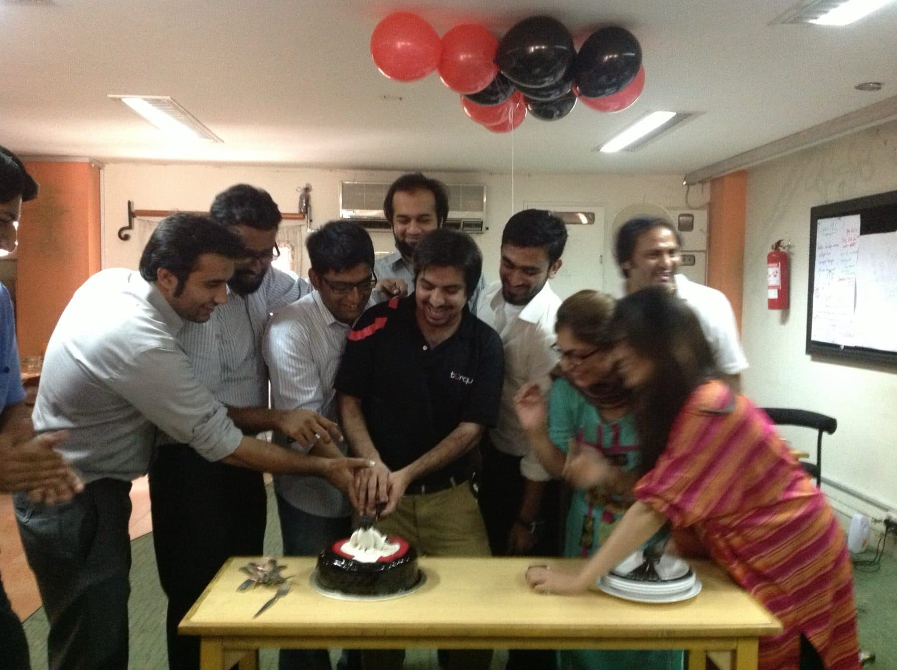 The Torque team together at work, out of the client room
