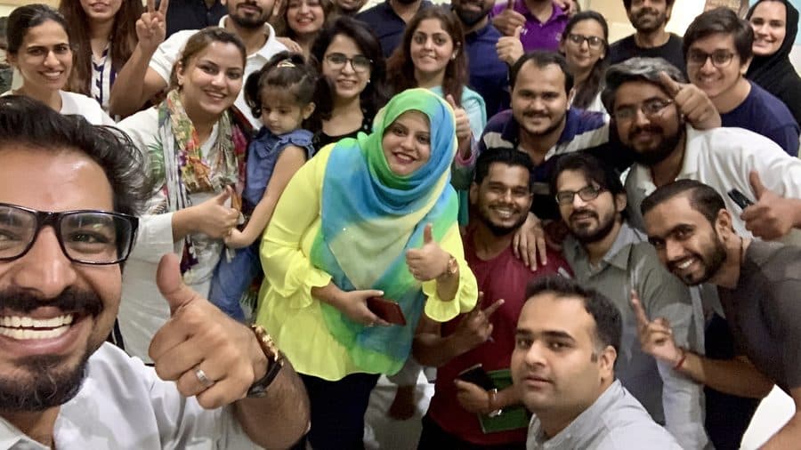 A room of participants and trainers crowded into one photograph
