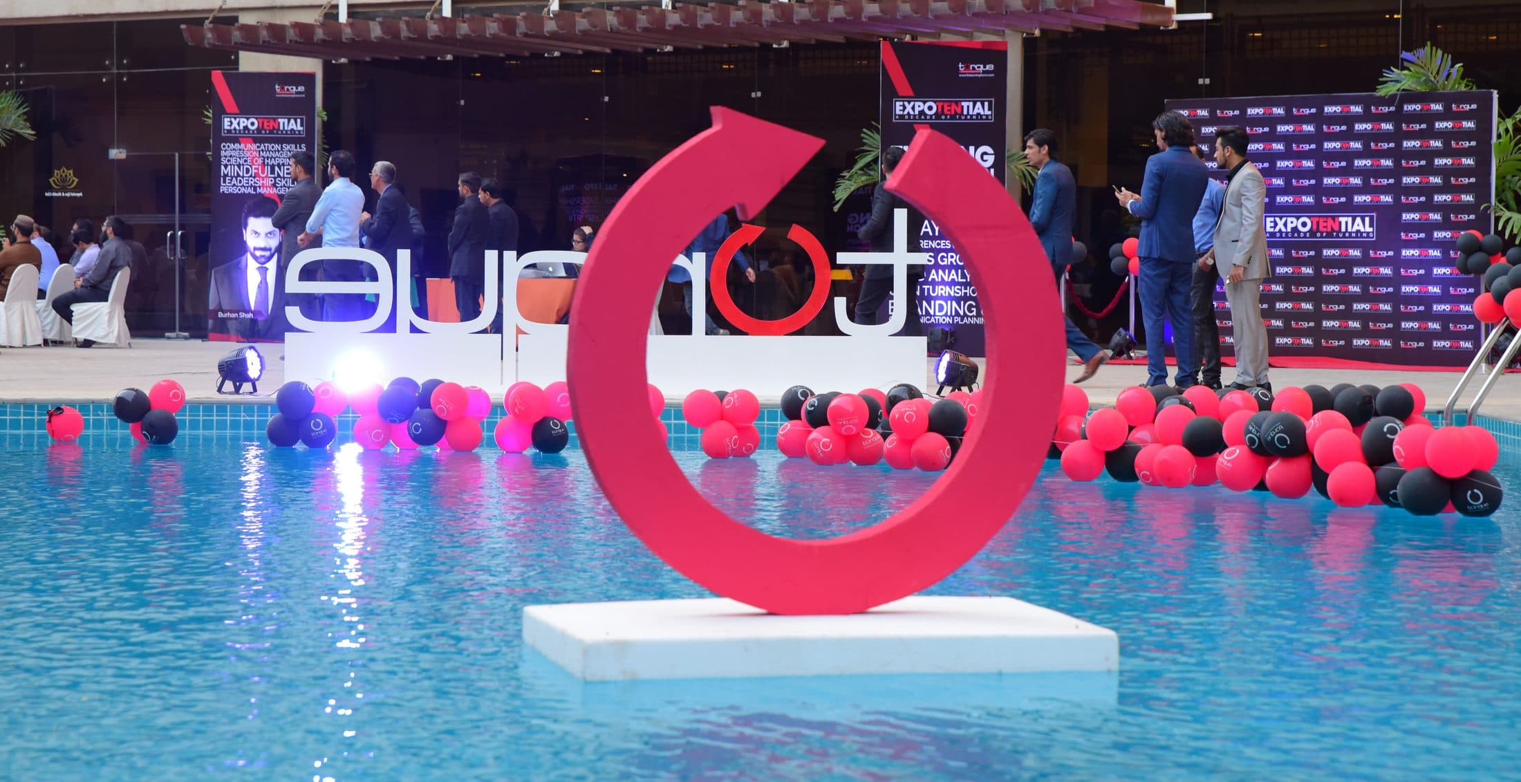 The Torque turn mark built as a sculpture, standing in a pool at ExpoTential