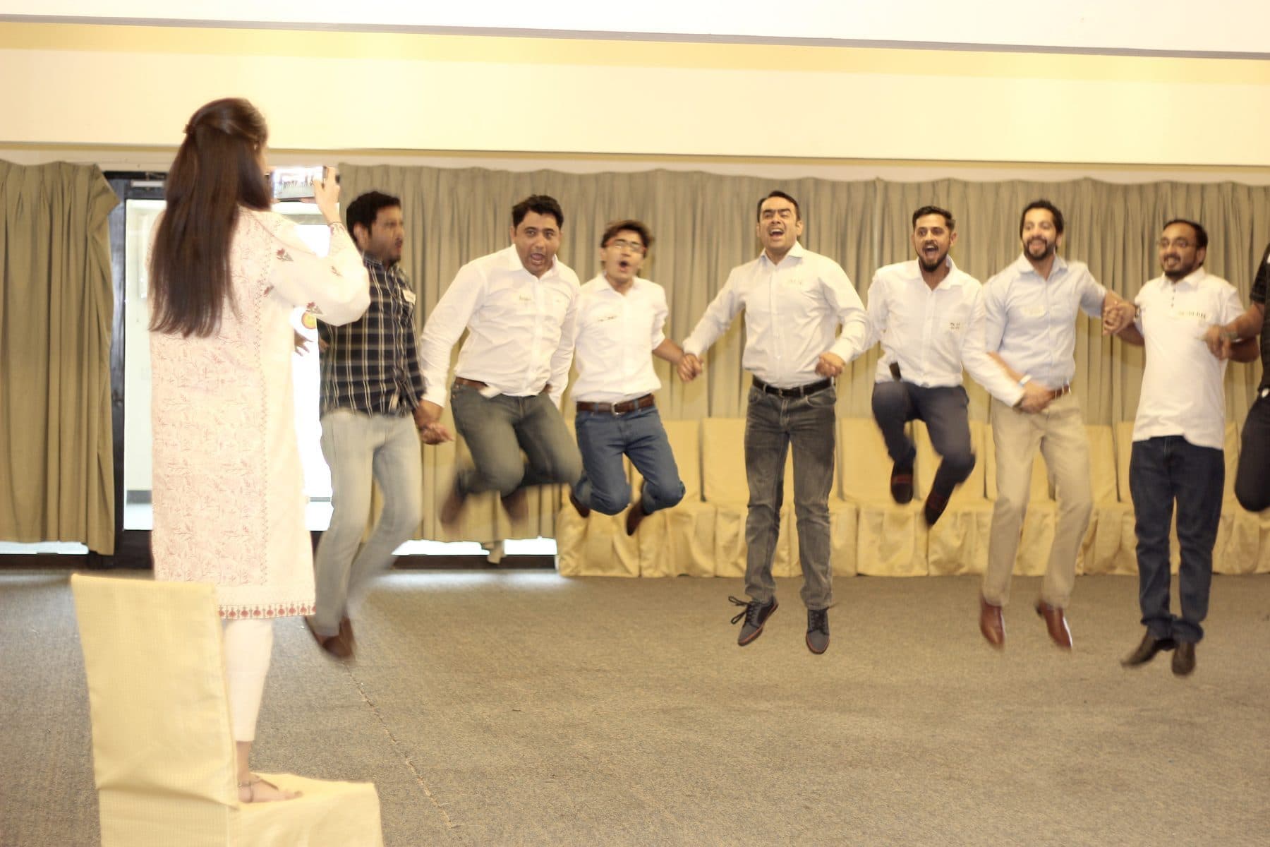 A line of participants caught mid-jump, all of them off the floor at once